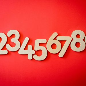 Creative display of numbers one to nine on a vibrant red background, ideal for educational materials.